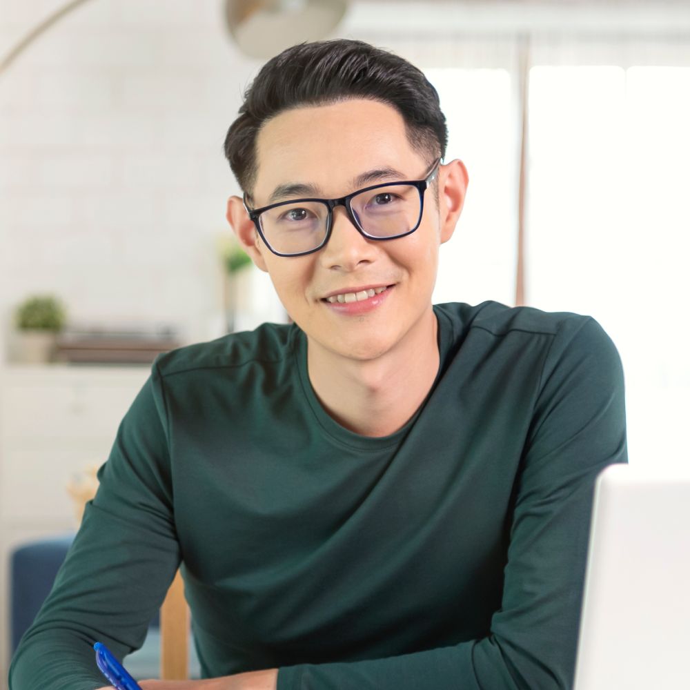 smiling handsome asian businessman working from ho vgxejqq 1.jpg